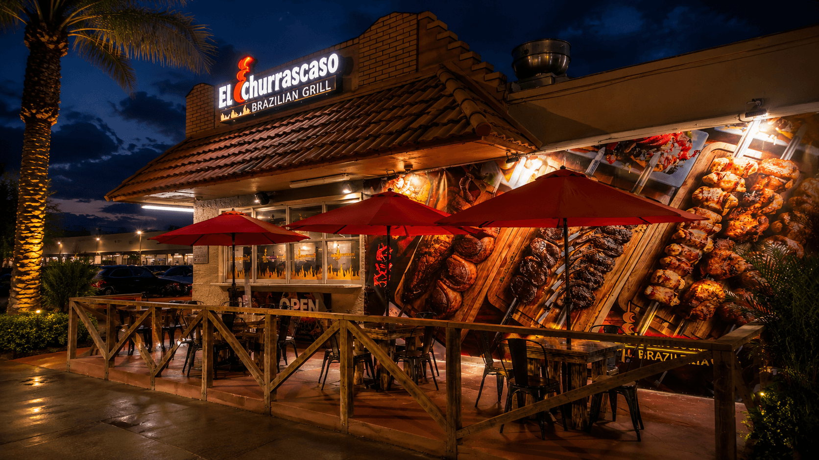 El Churrascaso Brazilian Grill at dusk with illuminated channel-letter signage and a large grilled-meats wall mural