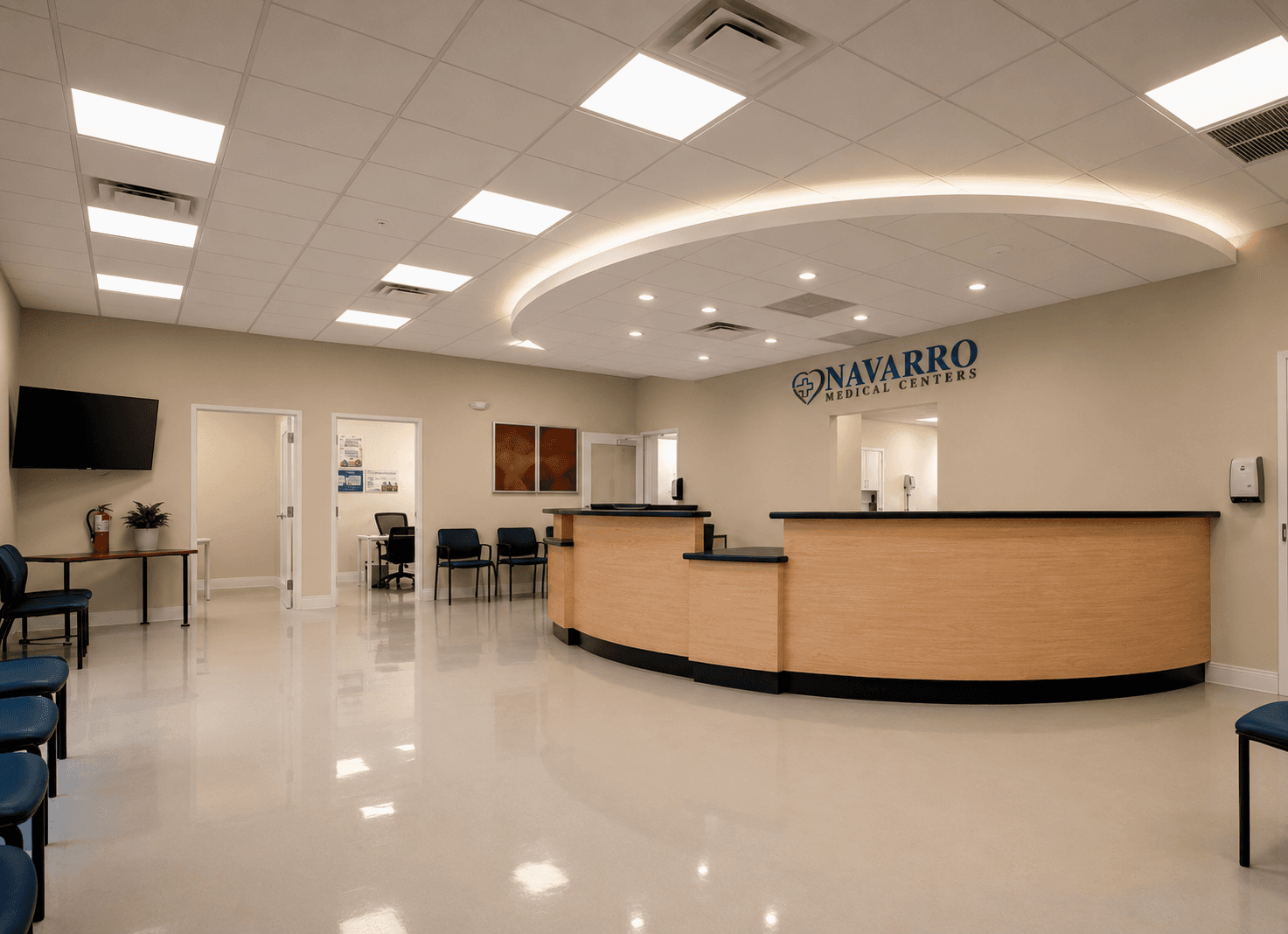 Modern Navarro Medical Centers reception area with a curved wood counter and illuminated wall sign